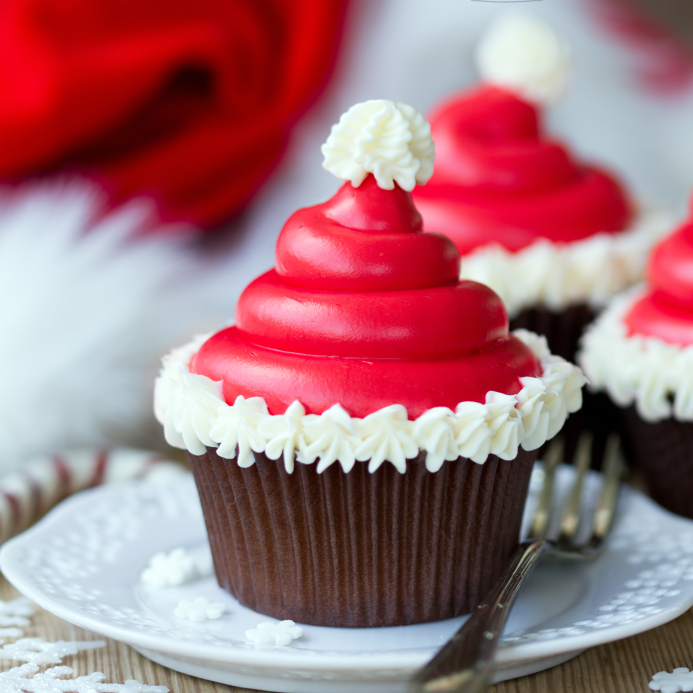Cupcakes decorated with buttercream santa hats