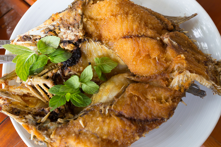 Fried snapper topped with sweet fish sauce with herbs